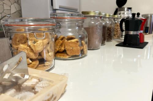 a group of jars filled with food on a counter at I TREPPONTI in Comacchio