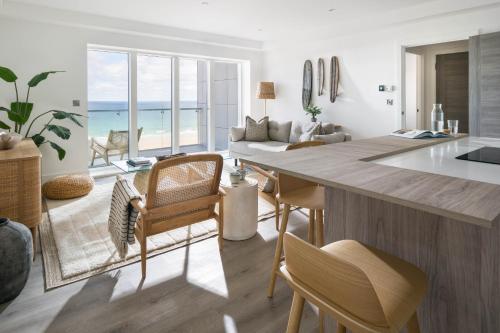 a kitchen and living room with a view of the ocean at Cliff Edge in Newquay