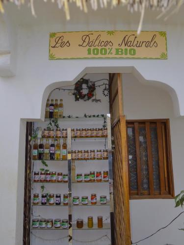 a refrigerator filled with lots of jars of food at La Case a Mamy in Nianing