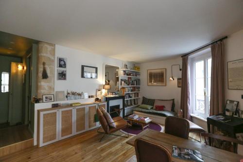 a living room with a couch and a table at Pretty nest near Canal St Martin in Paris