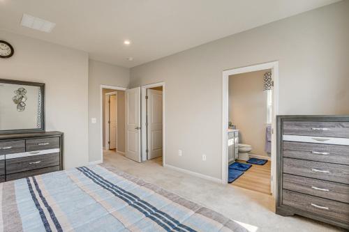 a bedroom with a bed and a dresser and a bathroom at 30 Mi to Downtown DC Charming Dale City Townhome! in Dale City
