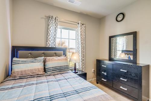 a bedroom with a bed with a dresser and a mirror at 30 Mi to Downtown DC Charming Dale City Townhome! in Dale City