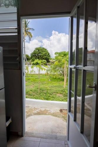 an open door with a view of a yard at Studio 1 Tinima with Garden access in Vieques