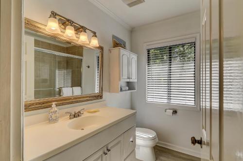 a bathroom with a sink and a toilet and a mirror at Beachwalk 200 in Hilton Head Island