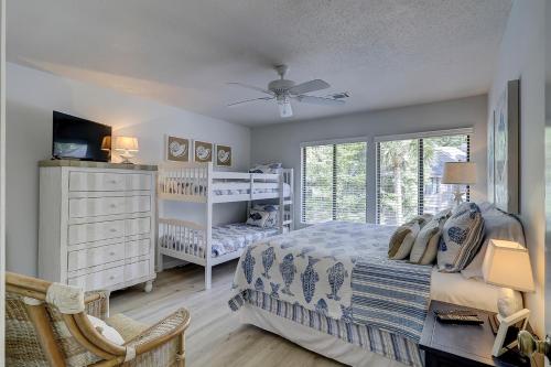 a bedroom with a bed and a dresser at Beachwalk 200 in Hilton Head Island