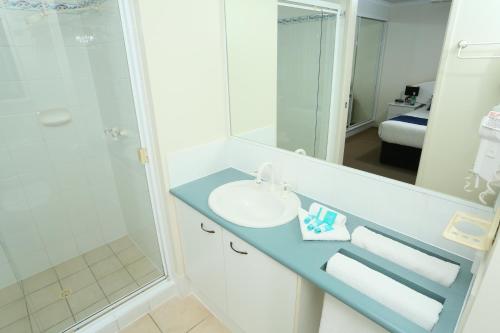 a bathroom with a sink and a shower at San Marino by the Sea Apartments in Marcoola