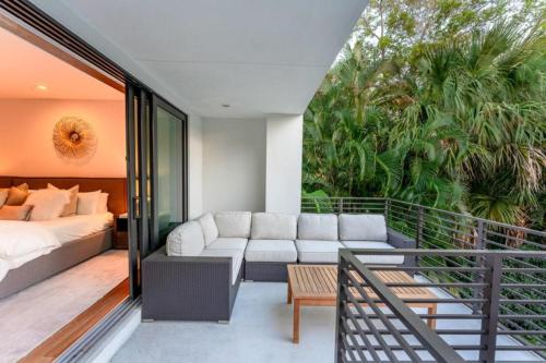 a living room with a couch and a bed on a balcony at Villa Celine in Fort Lauderdale