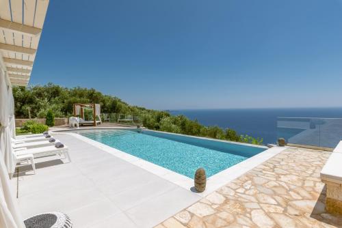 a swimming pool with a view of the ocean at PARGA Villas Collection in Parga