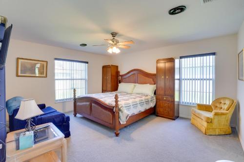 a bedroom with a bed and a chair at Walk to Lake Home with Screened Porch in Sebring! in Sebring