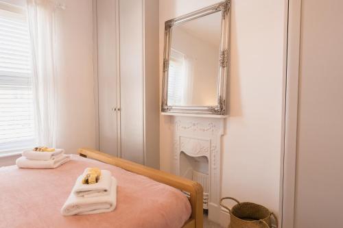 a bedroom with a bed with a mirror on the wall at Lovely 3 bedroom home in Hoole, Chester - Perfect for families in Chester