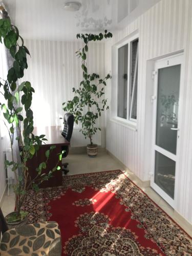 a room with a table and a red rug at Готель МАЙОВИТ in Khmelʼnytsʼkyy