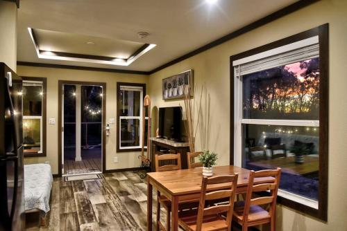 a living room with a wooden table and a dining room at Lone Star Tiny Home - 15 minutes to downtown in Austin