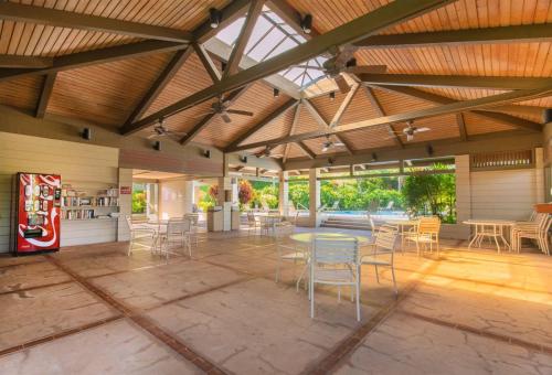 a patio with tables and chairs in a building at 1915 Ridge in Kahana