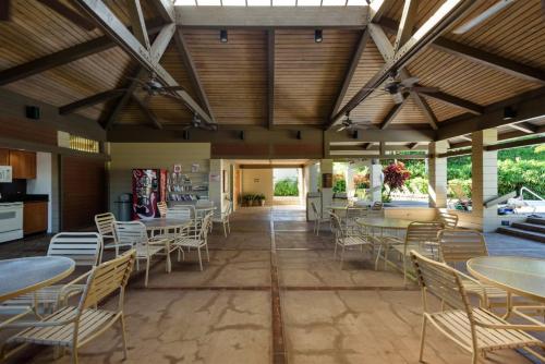 a dining room with tables and chairs in a building at 1915 Ridge in Kahana