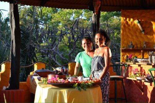 a man and a woman standing next to a table at El Castillo Divertido in Paraíso