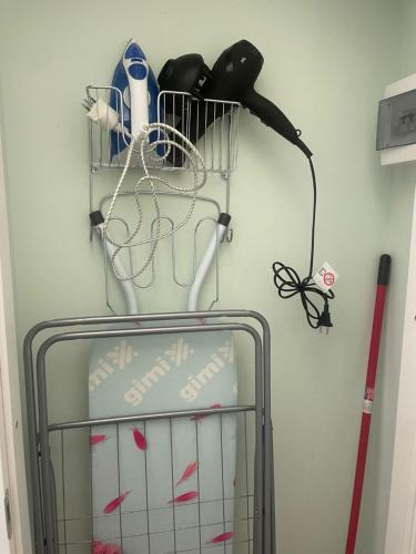 a wire rack with some items on a wall at Monolocale Salvia Self check in in Pavia