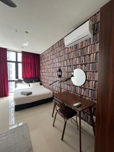 a bedroom with a bed and a desk with a lamp at THE SHORE KOTA KINABALU 5Pax Family Room in Kota Kinabalu