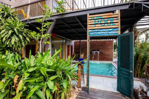 a house with a swimming pool and a green door at Homestay ECO MAY5 TRAVEL in Ha Long