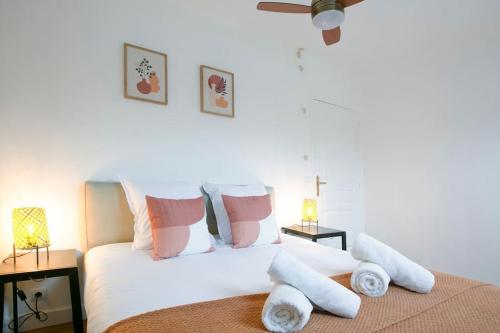 une chambre avec un lit avec des draps blancs et des oreillers dans l'établissement Skyline Parisian Flat - Exclusif Saint-Honoré, à Paris