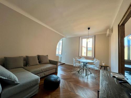 a living room with a couch and a table at BIG Historical Colonne in Milan