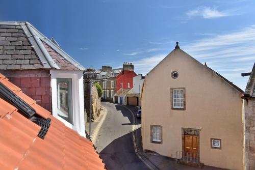 a view of a street in a town with buildings at Penthouse on the Harbour - Pittenweem in Pittenweem