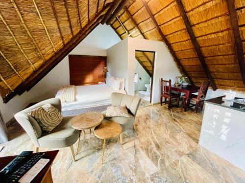 a bedroom with a bed and a desk in a room at Pretoria Mansion Boutique Hotel Coral Tree in Pretoria