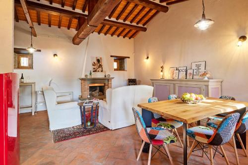 a living room with a wooden table and chairs at Casale Margherita in Cortona