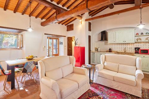 a living room with two chairs and a table at Casale Margherita in Cortona