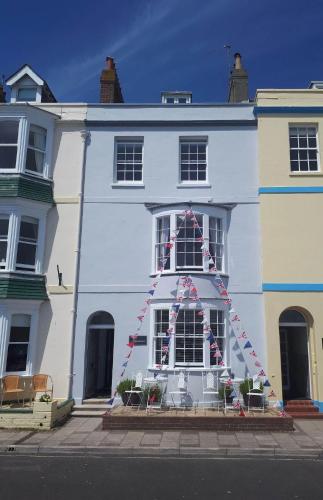 a white house with a christmas decoration in the window at Seasons in Weymouth