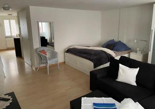 een woonkamer met een bed en een bank bij 1.5 Zimmer Wohnung Altstadt Zug in Zug