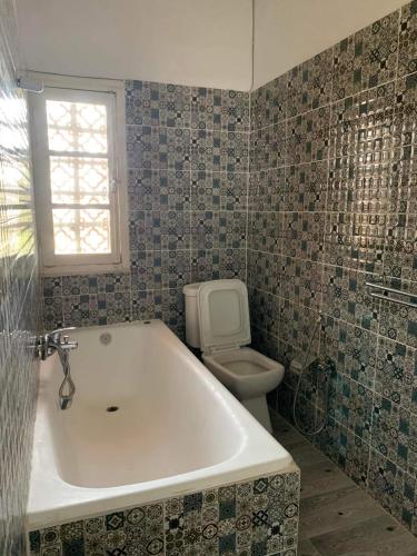 a bathroom with a bath tub and a toilet at Hotel les Remparts in Sicca Veneria