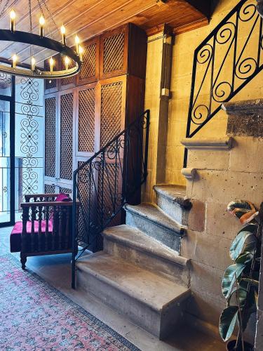 a set of stairs in a building with a chandelier at Four Mansions Hotel in Kayseri