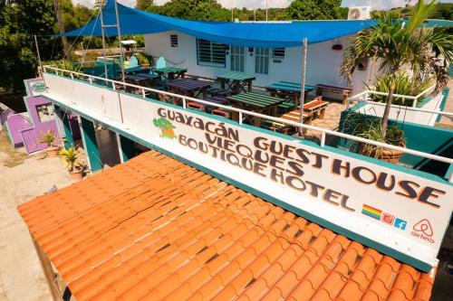 a boat with a sign that reads gamedan guest house at Beachfront Suite 6 Karaya in Vieques