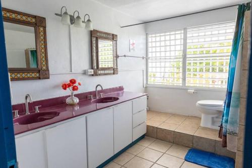 a bathroom with two sinks and a toilet at Beachfront Suite 6 Karaya in Vieques