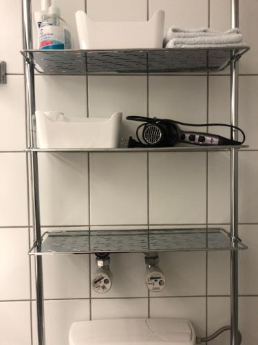 a shelf in a bathroom with toiletries at Rosenalm App 23 in Scheidegg