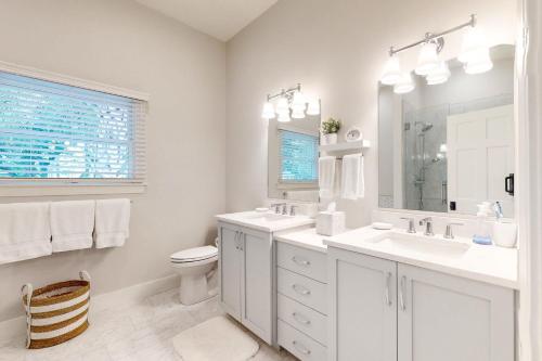 Baño blanco con 2 lavabos y aseo en 44 Muirfield Ln, en Kiawah Island