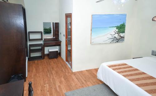 a bedroom with a bed and a desk and a window at Holiday Home Kelaa Retreat in Kelaa