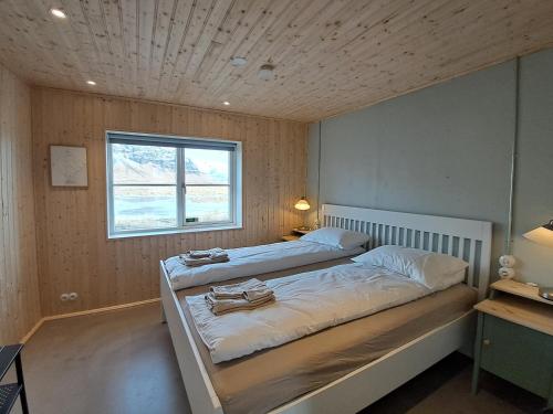 una camera con due letti e una finestra di The forgotten farmhouse a Skogar