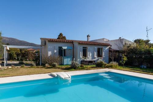 a villa with a swimming pool in front of a house at Casa Vacanze Mar Bea in Terra Mala
