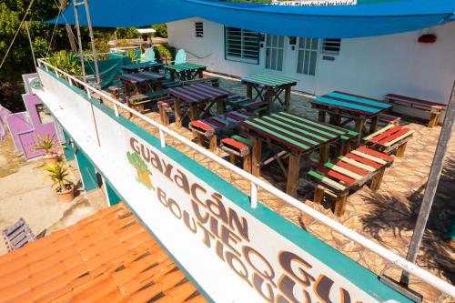 a group of tables and chairs on the deck of a boat at Beachfront Suite 7 Atabey in Vieques