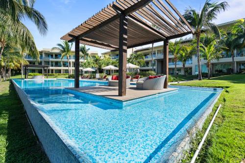 a swimming pool with a gazebo next to a resort at Stylish Peninsula Golf 3BR Oasis with Pool in Nuevo Vallarta