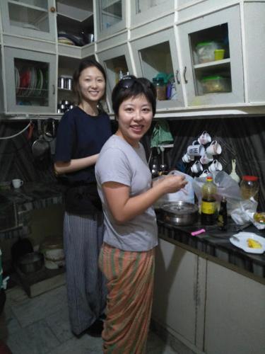 two women are standing in a kitchen at MYE Home stay near golden temple in Amritsar