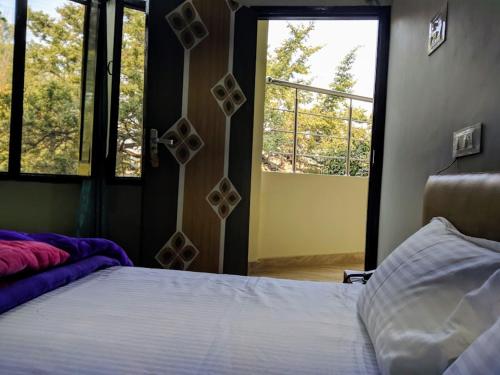 um quarto com uma cama e uma grande janela em mye Home stay near golden temple em Amritsar