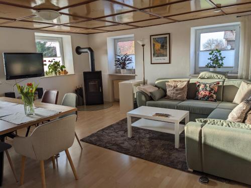 a living room with a couch and a table at Allgäu Apartment in Memmingen