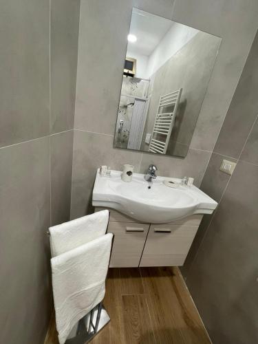 a bathroom with a sink and a mirror at Relax Apartment 39 in Crotone