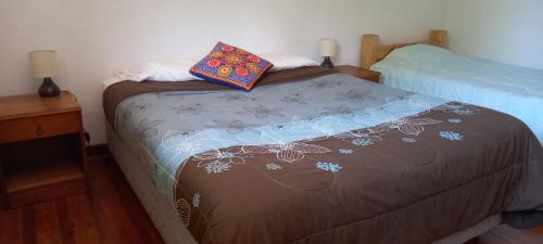 a bedroom with two beds and two pillows at Terrandino in San José de Maipo