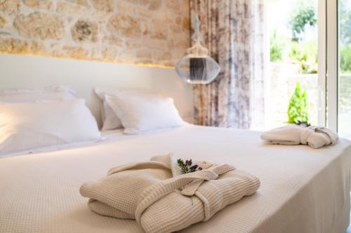 a bedroom with a bed with towels on it at PARGA Villas Collection in Parga