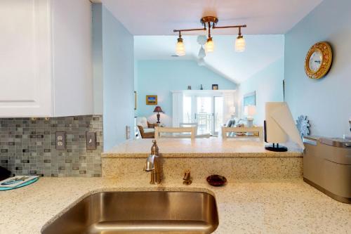 a kitchen with a sink and a living room at 13104 Pelican Watch in Seabrook Island