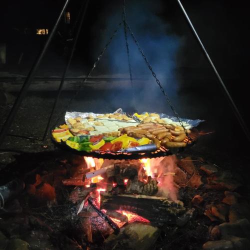 a plate of food on top of a fire at Wetlina Poza Trasą in Wetlina