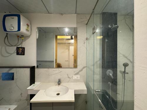 a bathroom with a sink and a shower at The Grand Anukampa By Zen Den in Jaipur